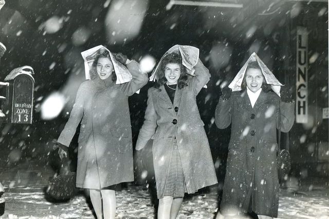 More Coming, Pearl Reep, Belle Dodds, and Ruth Hassen, All of Flushing, Covering Their Heads as They Walk Along Chambers St., February 1946 // Bernie Aumuller<br/>